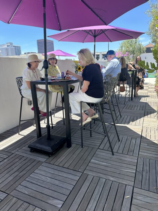 Advisors eating lunch at rooftop party in Los Angeles